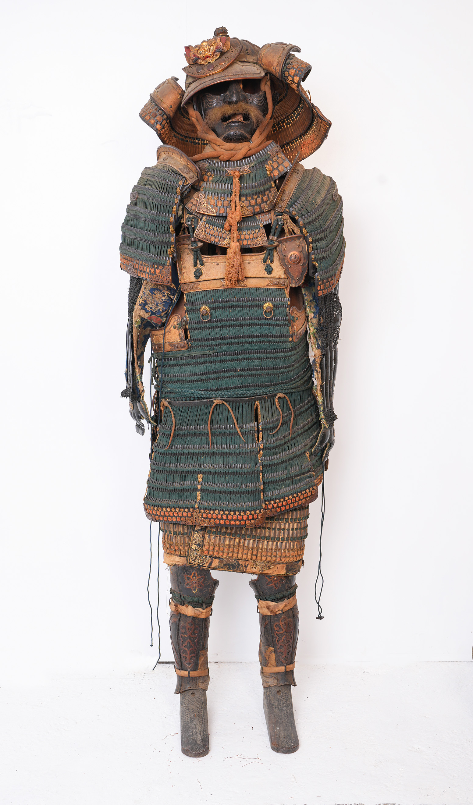 A Japanese 18th century Samurai Warriors Armour fitted with menpo facial armour, a kabuto helmet