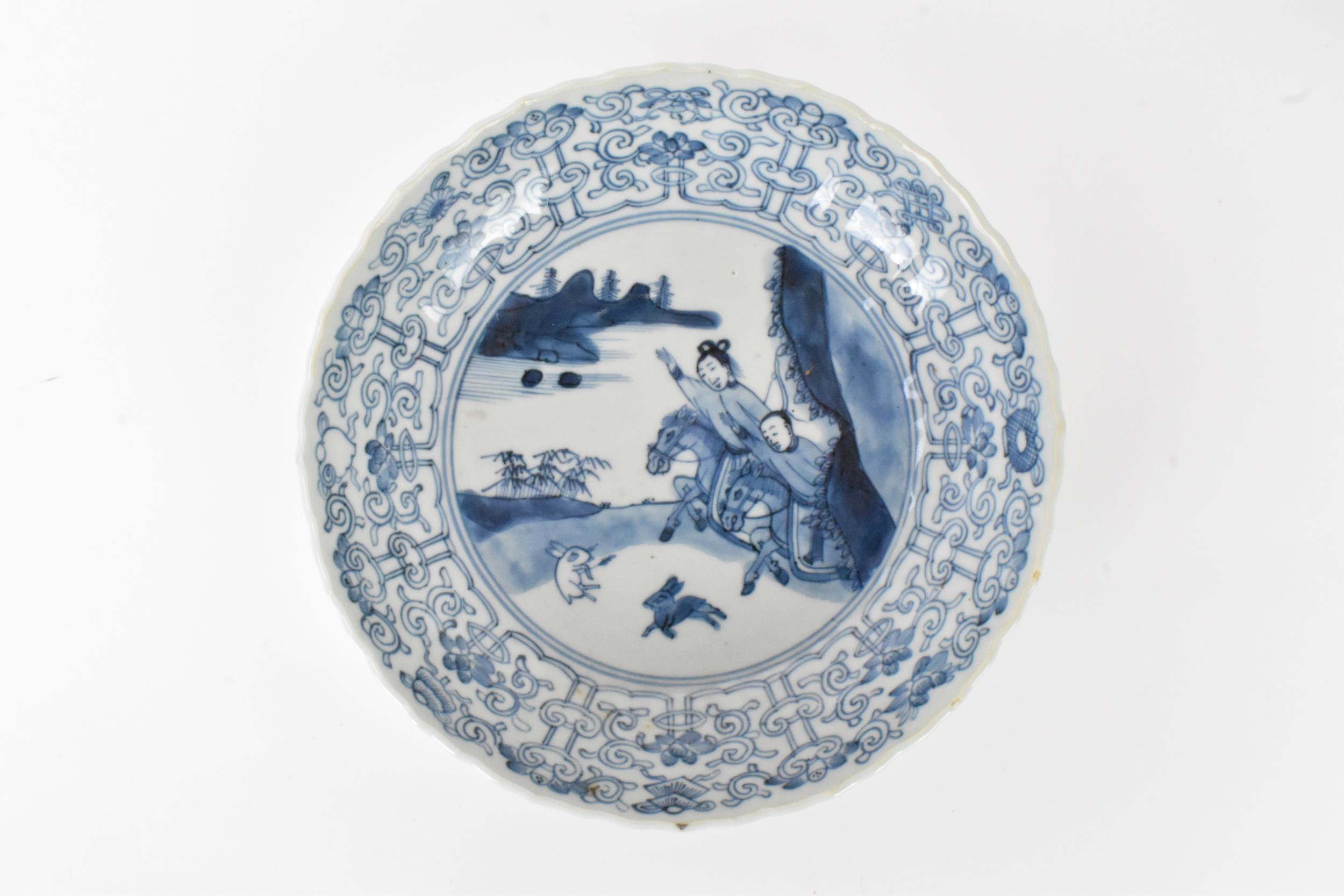 A pair of Qing Dynasty blue and white dishes, with fluted sides and barbed rim, decorated on the - Image 7 of 9