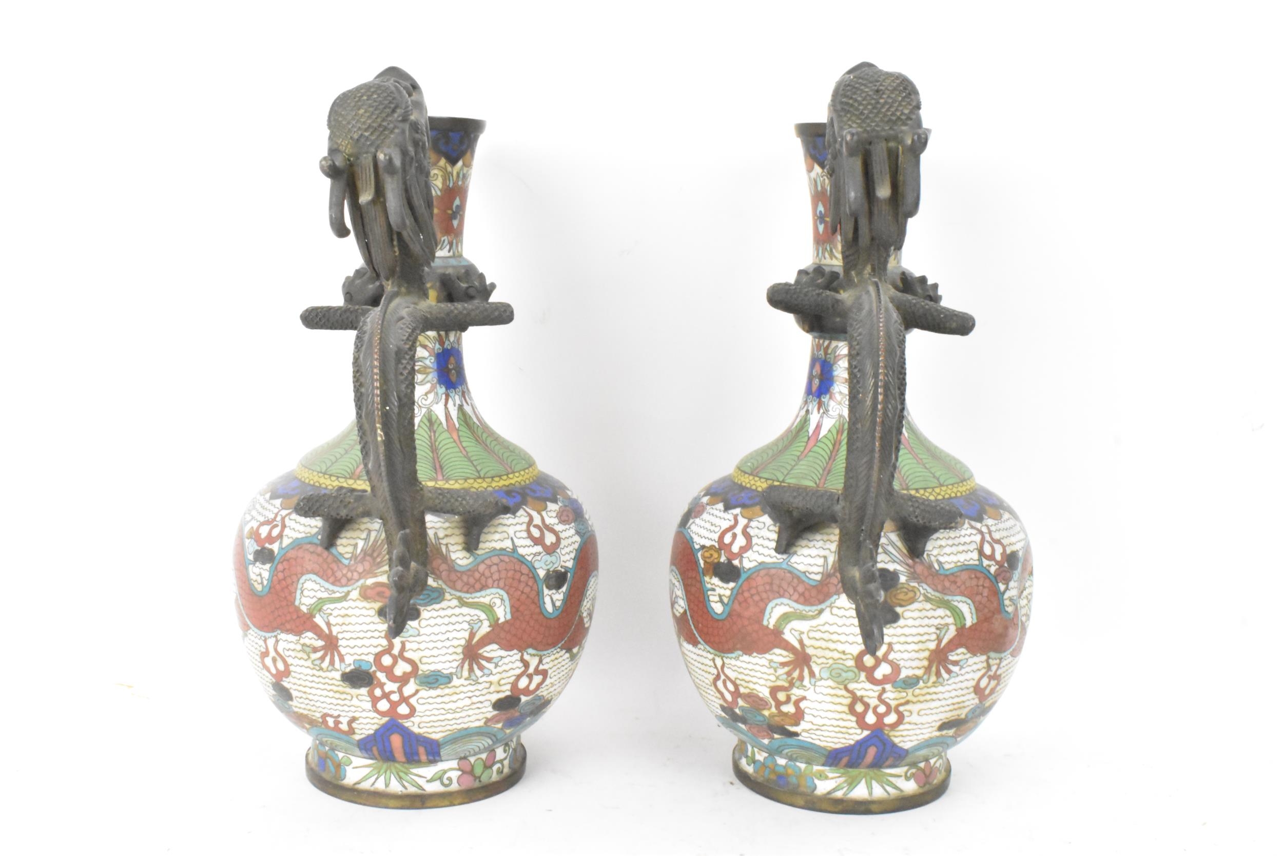 A pair of Chinese late Qing dynasty cloisonne ewers, both having a handle modelled in the form of - Image 2 of 6