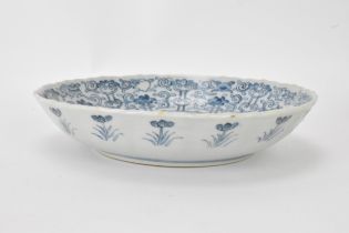 A pair of Qing Dynasty blue and white dishes, with fluted sides and barbed rim, decorated on the
