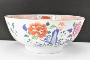 A Chinese famille rose punch bowl, Qianlong, mid 18th century, painted with foliage and the border
