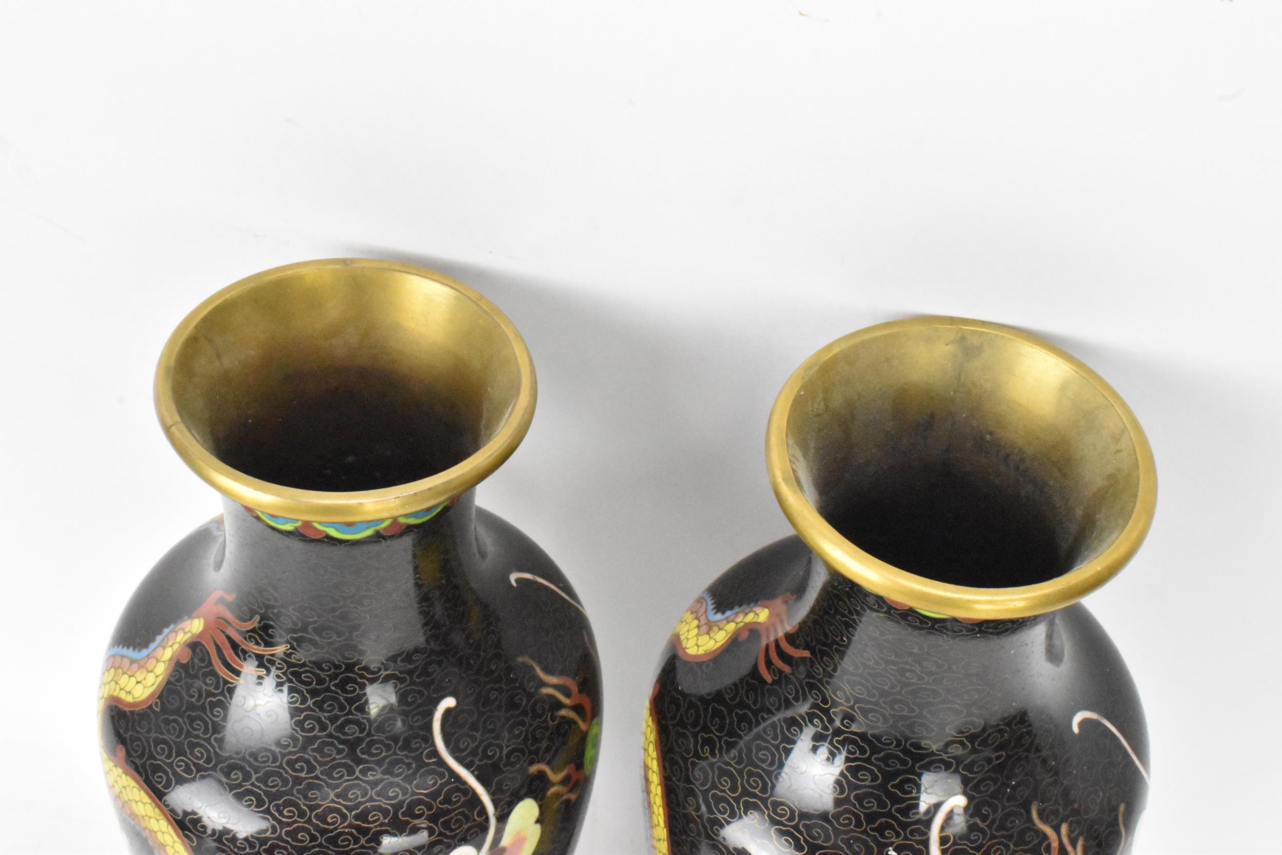 A pair of Chinese mid 20th century cloisonne vases, with black grounds decorated with confronting - Image 5 of 6