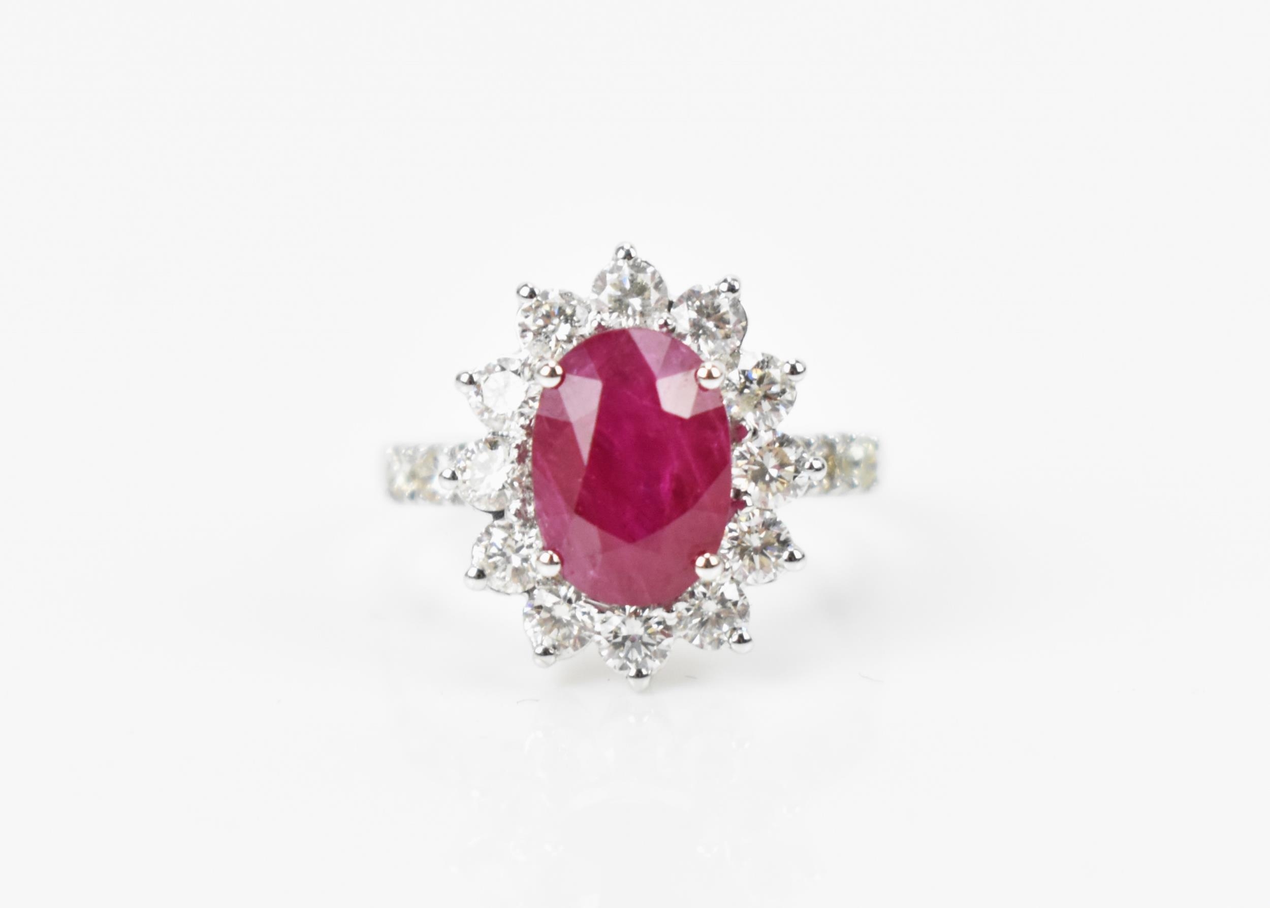 An 18ct white gold, diamond and ruby dress ring, set with central oval mixed cut ruby in four claw - Bild 11 aus 12