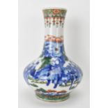 A Chinese Famille Vert bottle neck vase, decorated with figures, horse and butterflies in a