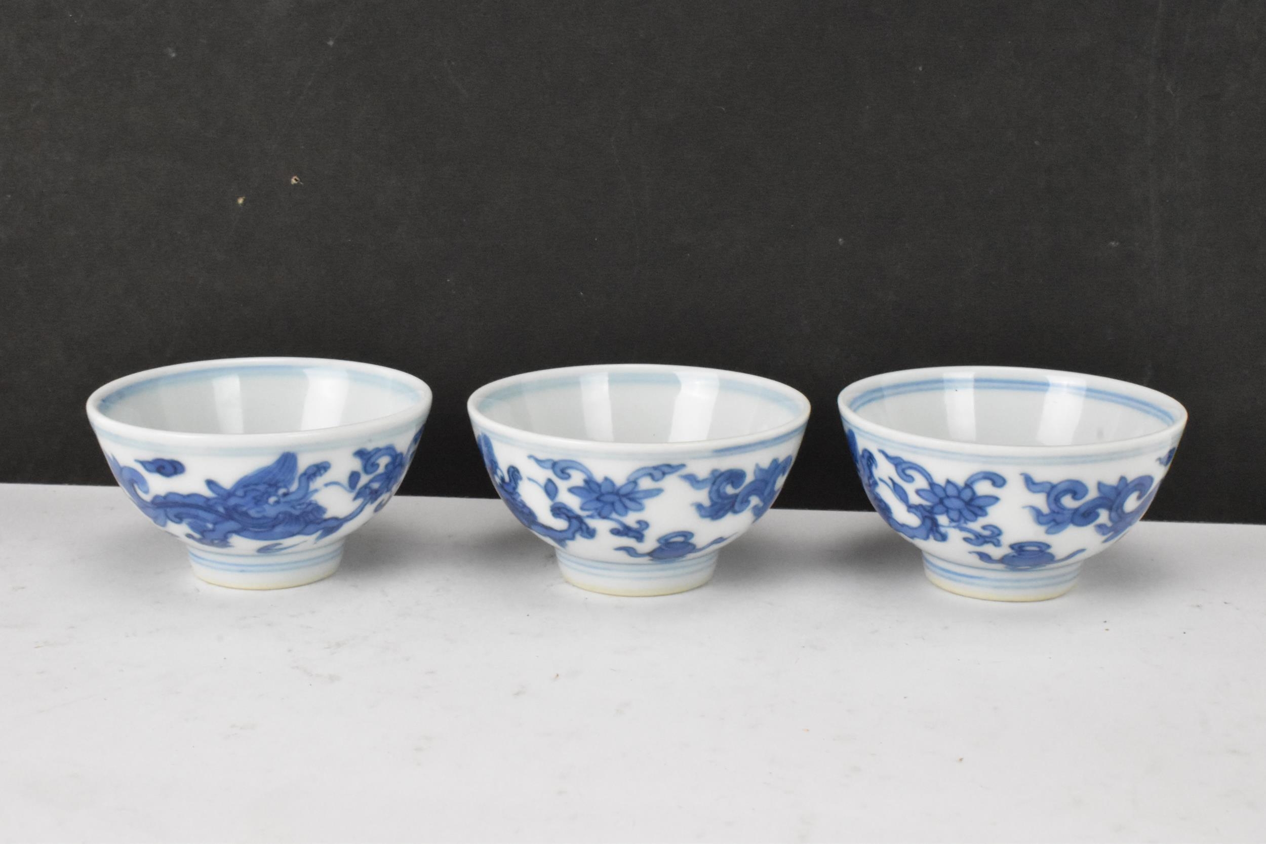 Three Chinese 20th century blue and white bowls, decorated with dragons and interiors with central - Image 3 of 9