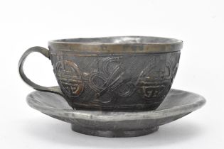 A Chinese late 19th/early 20th century coconut carved cup and saucer, both with pewter liners and