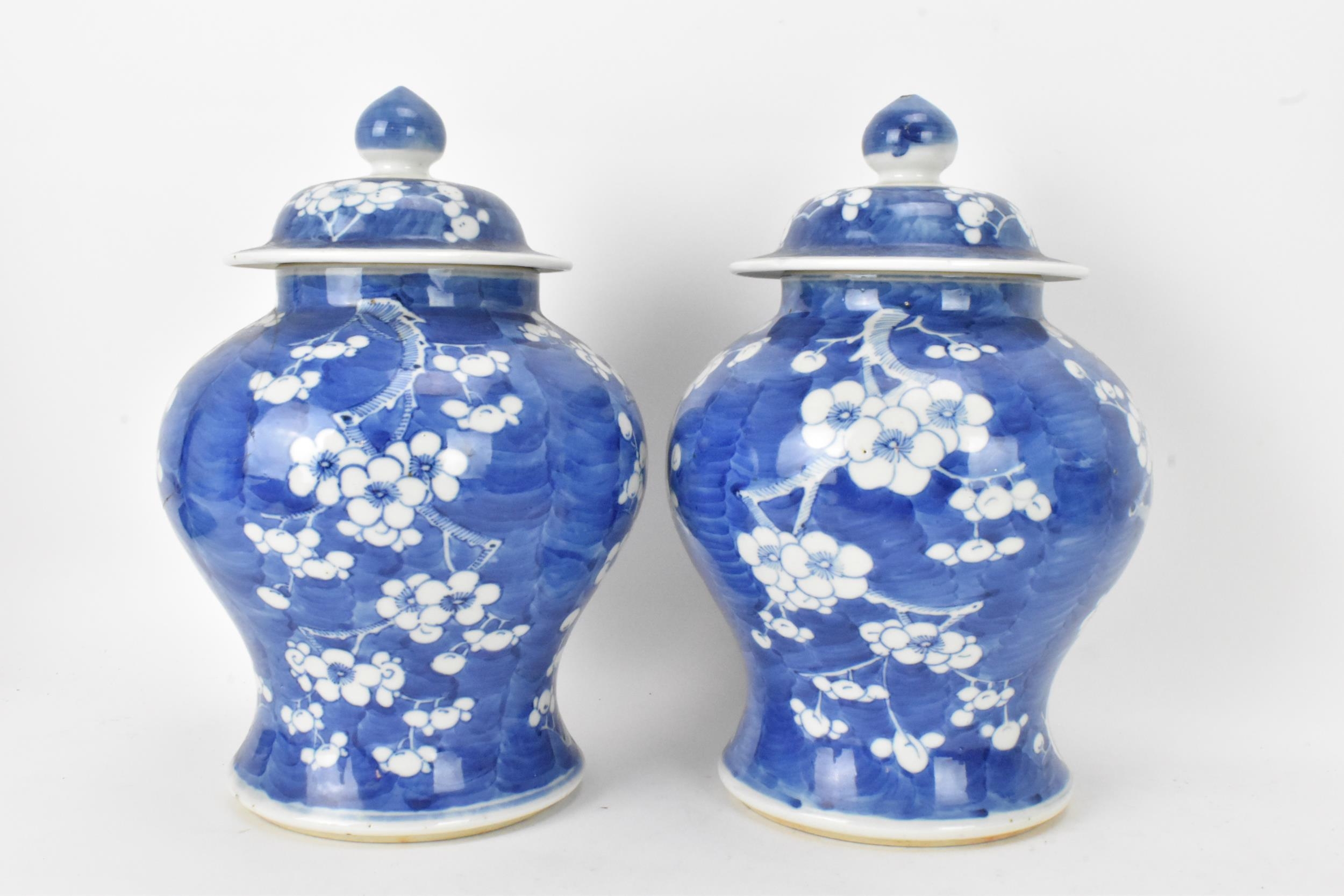 A pair of Chinese prunus pattern blue and white vases, late Qing Dynasty, both of baluster form with - Image 4 of 8