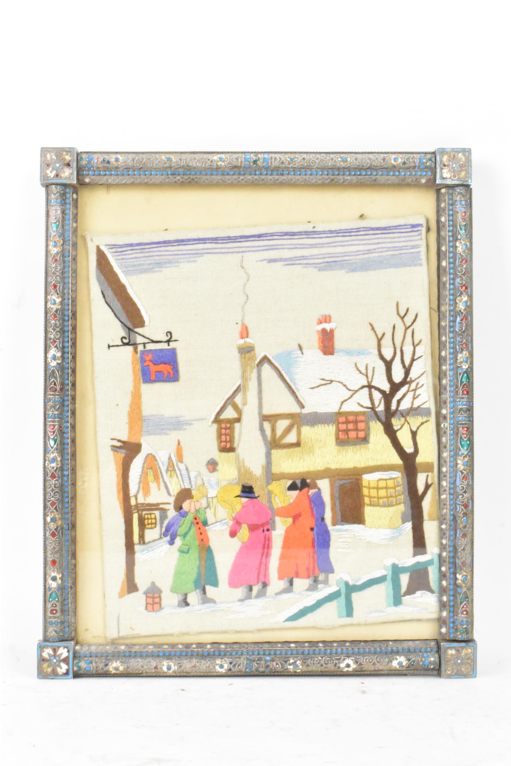 A Russian silver early 20th century champleve enamel photograph frame, inset with a tapestry and