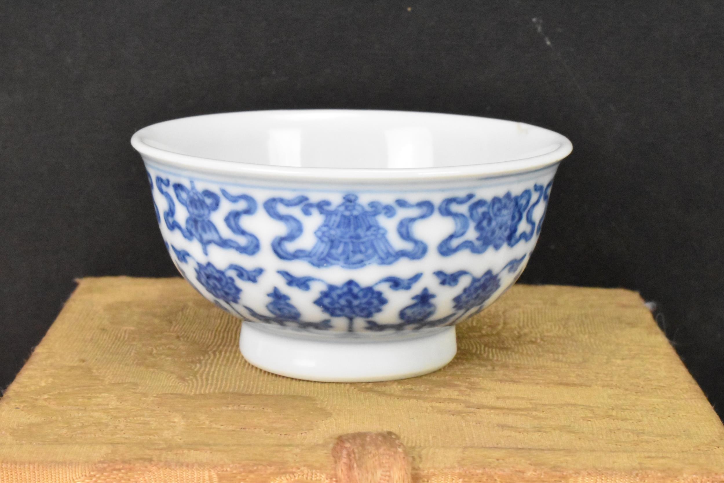 A Chinese blue and white tea bowl, decorated with lotus flowers among stylized scroll decoration