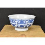 A Chinese blue and white tea bowl, decorated with lotus flowers among stylized scroll decoration