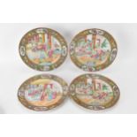 A set of four Chinese export Canton Famille Rose plates, Qing Dynasty, late 19th century, each
