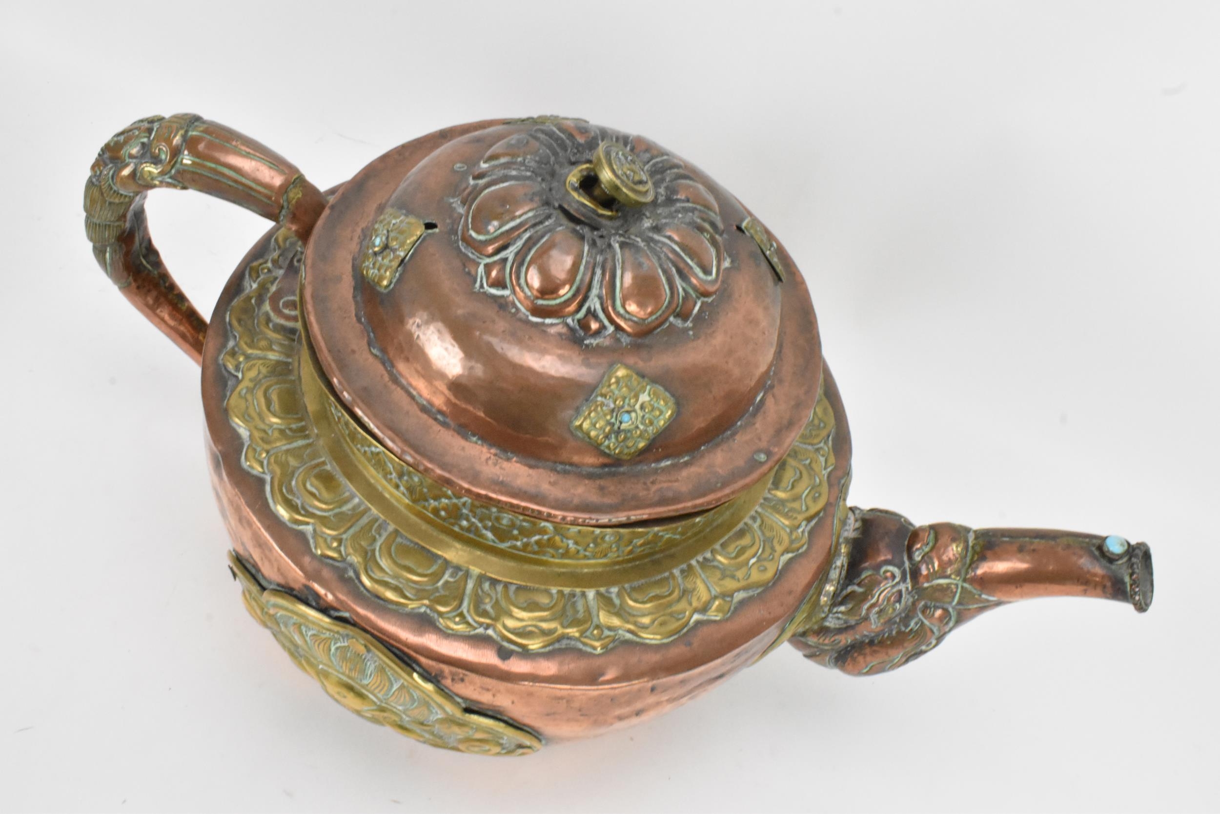 A 19th century Tibetan brass and copper large teapot, having an elephant formed spout, applied - Image 5 of 7