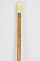 A late 19th/early 20th century walking stick, with an ivory knop handle inset with a compass, nickel