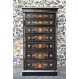 A late Victorian ebonised wellington chest of seven graduating drawers, applied gilt beading and