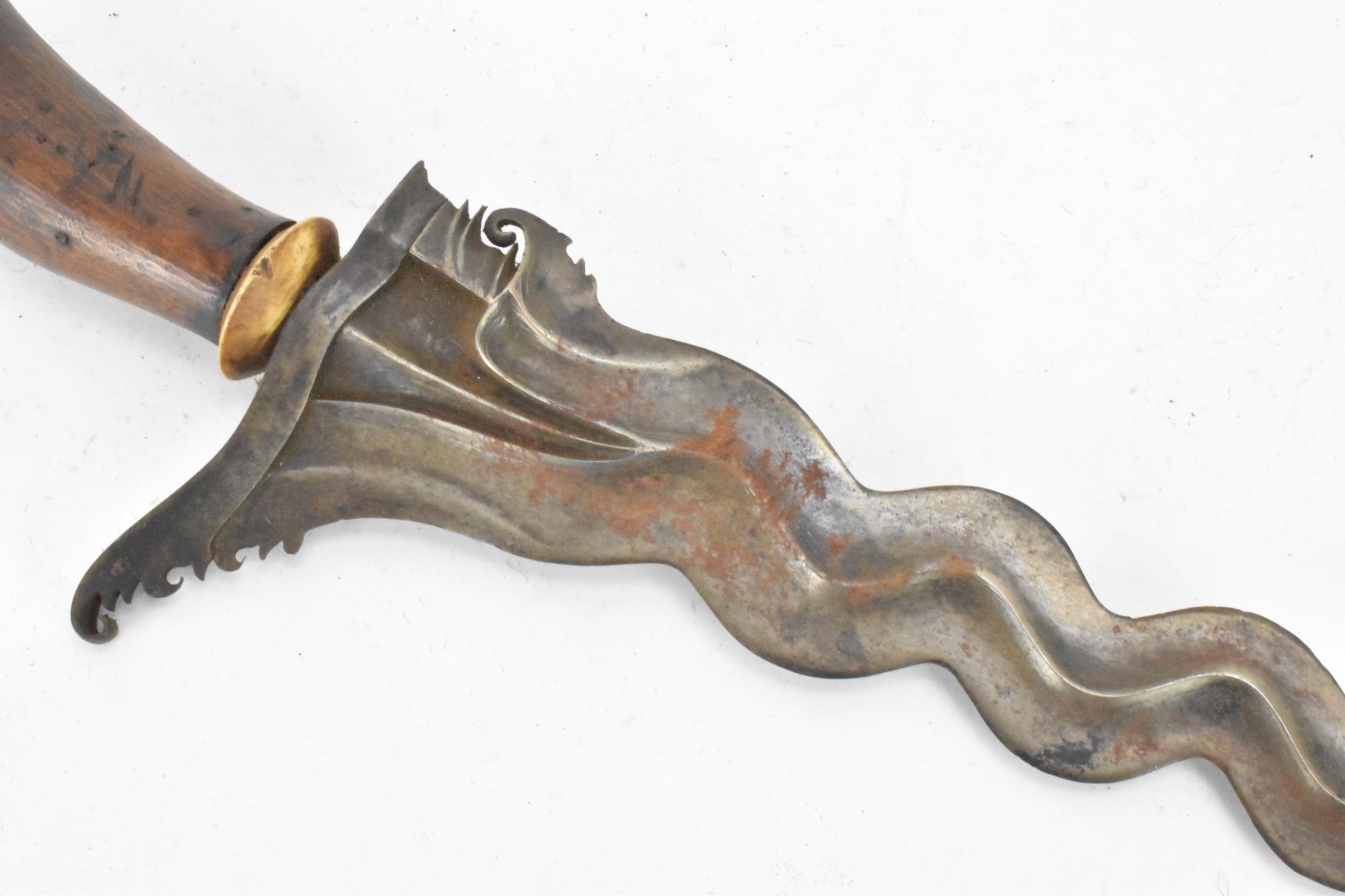 A 19th century Malayan Kris or Keris, having a double edged wavy blade with undulations, raised - Image 5 of 8