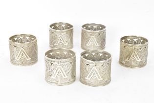 A set of six early 20th century Middle Eastern white metal filigree napkin rings, elaborately