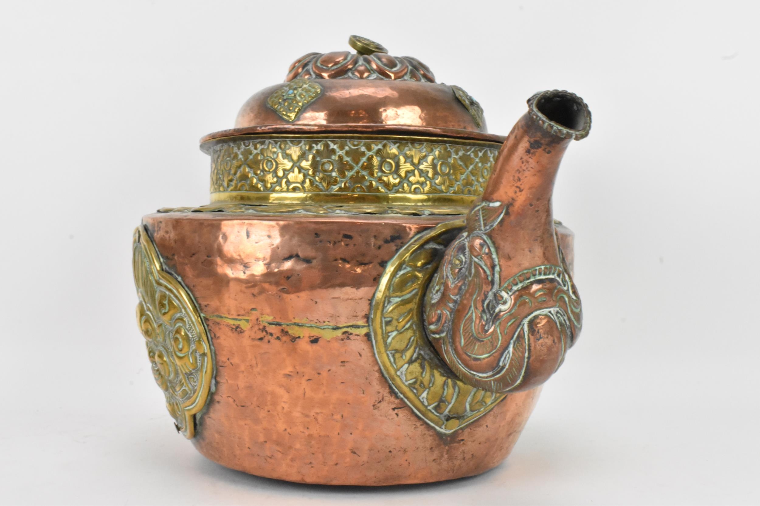 A 19th century Tibetan brass and copper large teapot, having an elephant formed spout, applied - Image 2 of 7