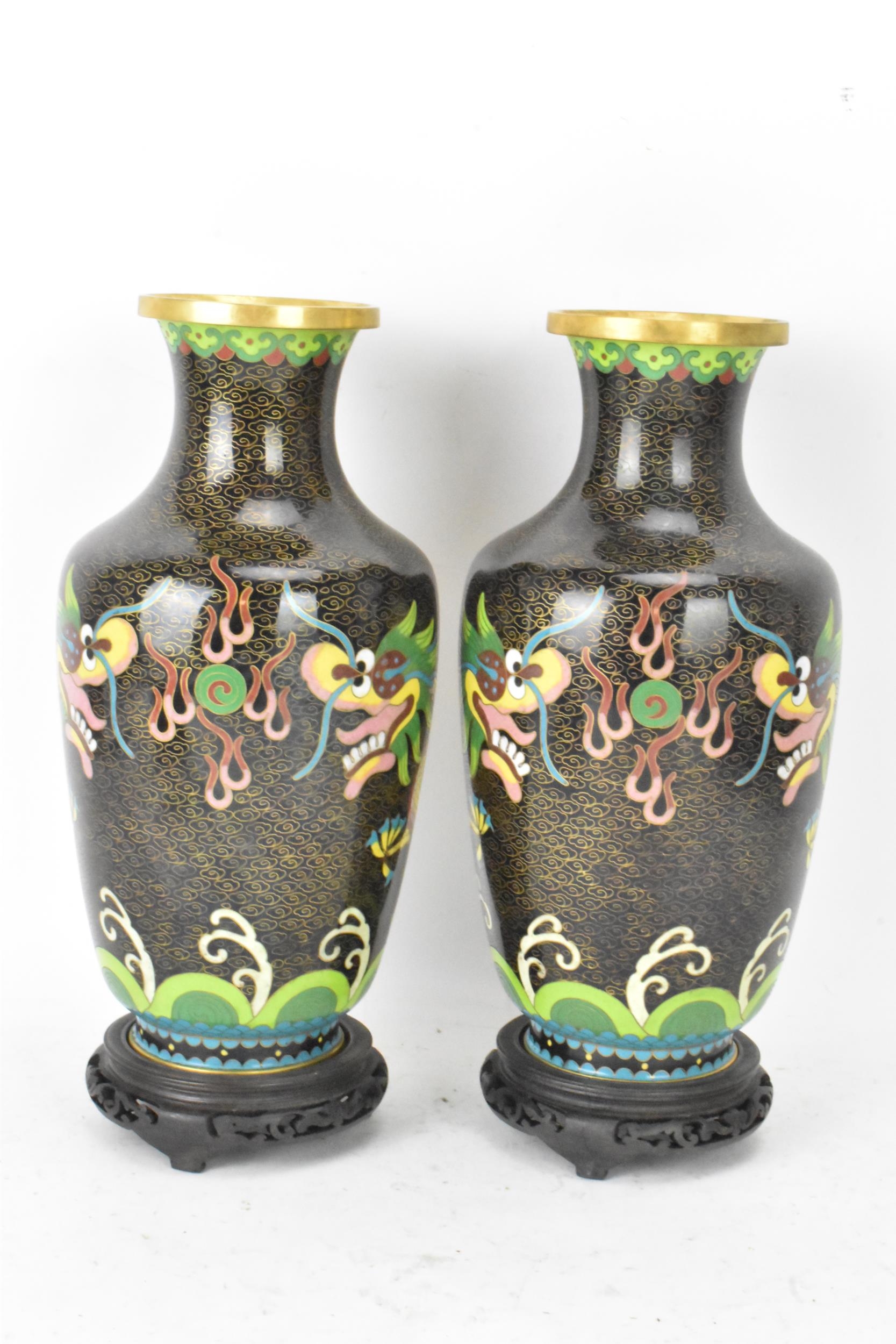 A pair of Chinese mid 20th century cloisonne vases and a bowl, all with black grounds decorated with - Image 3 of 12