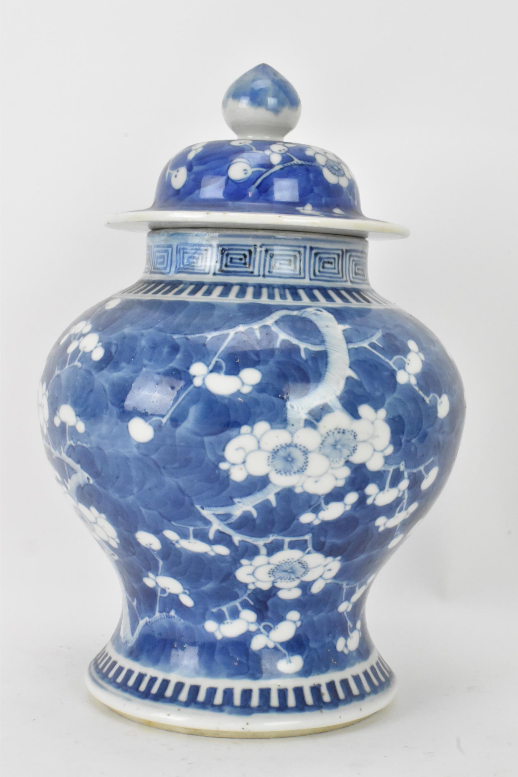 A Chinese prunus pattern blue and white vase, late Qing Dynasty, of baluster form with domed cover - Image 3 of 8