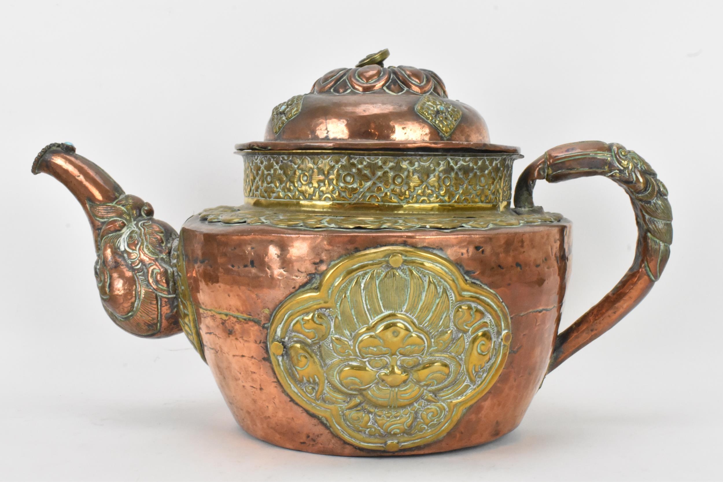 A 19th century Tibetan brass and copper large teapot, having an elephant formed spout, applied - Image 3 of 7