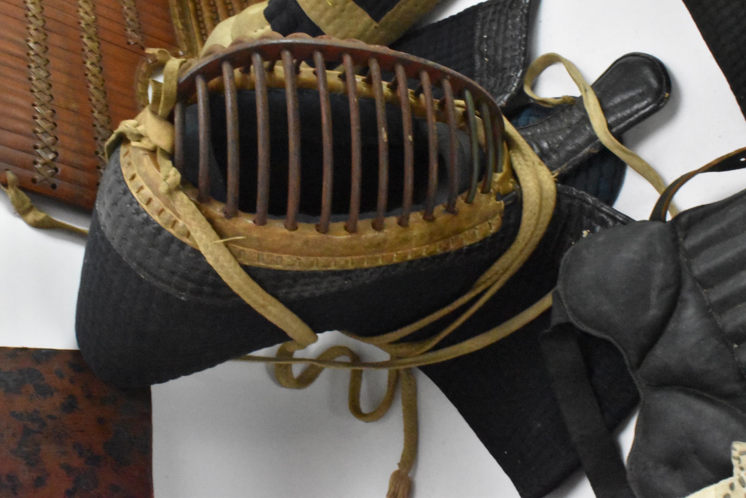 A Japanese Kendo uniform/suit of armour, comprising a helmet, knee pads, belts, jackets, hakama - Image 7 of 12