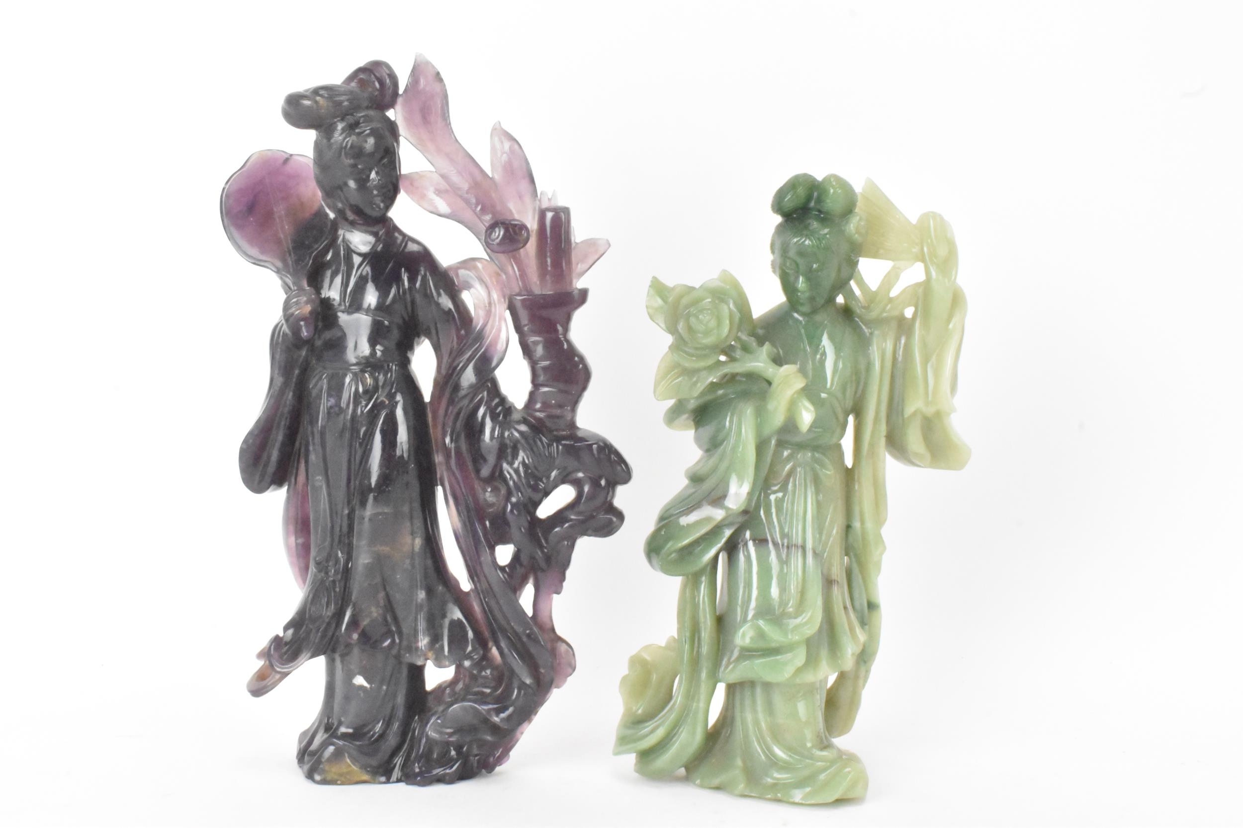 Two Chinese 20th century jadeite carved figures, the green example modeled holding a fan and flowers
