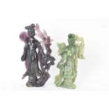 Two Chinese 20th century jadeite carved figures, the green example modeled holding a fan and flowers