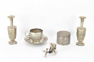 A small collection of Indian white metal implements including two vases with crimped tips and