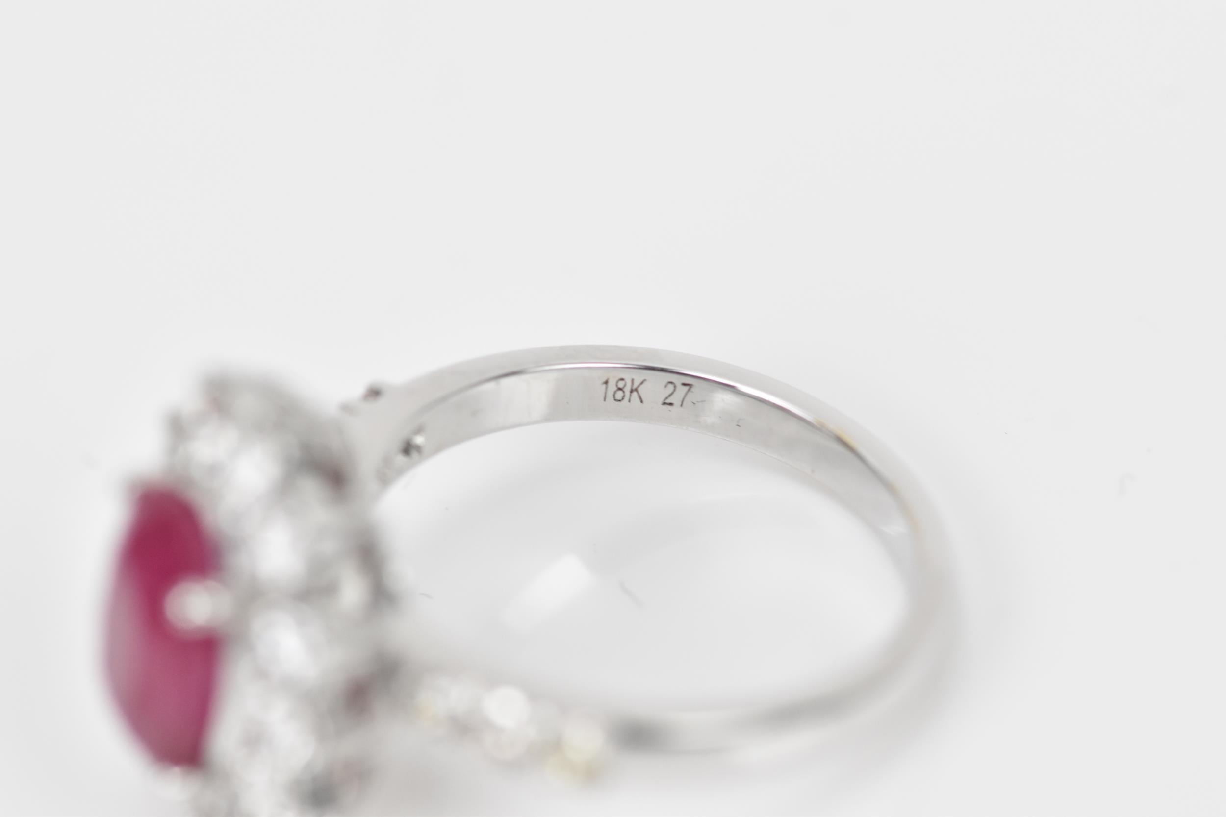 An 18ct white gold, diamond and ruby dress ring, set with central oval mixed cut ruby in four claw - Bild 7 aus 12