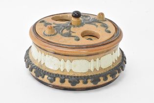 A rare and unusual Doulton stoneware container, possibly an inkwell with revolving lid, the well