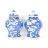 A pair of Chinese prunus pattern blue and white vases, late Qing Dynasty, both of baluster form with