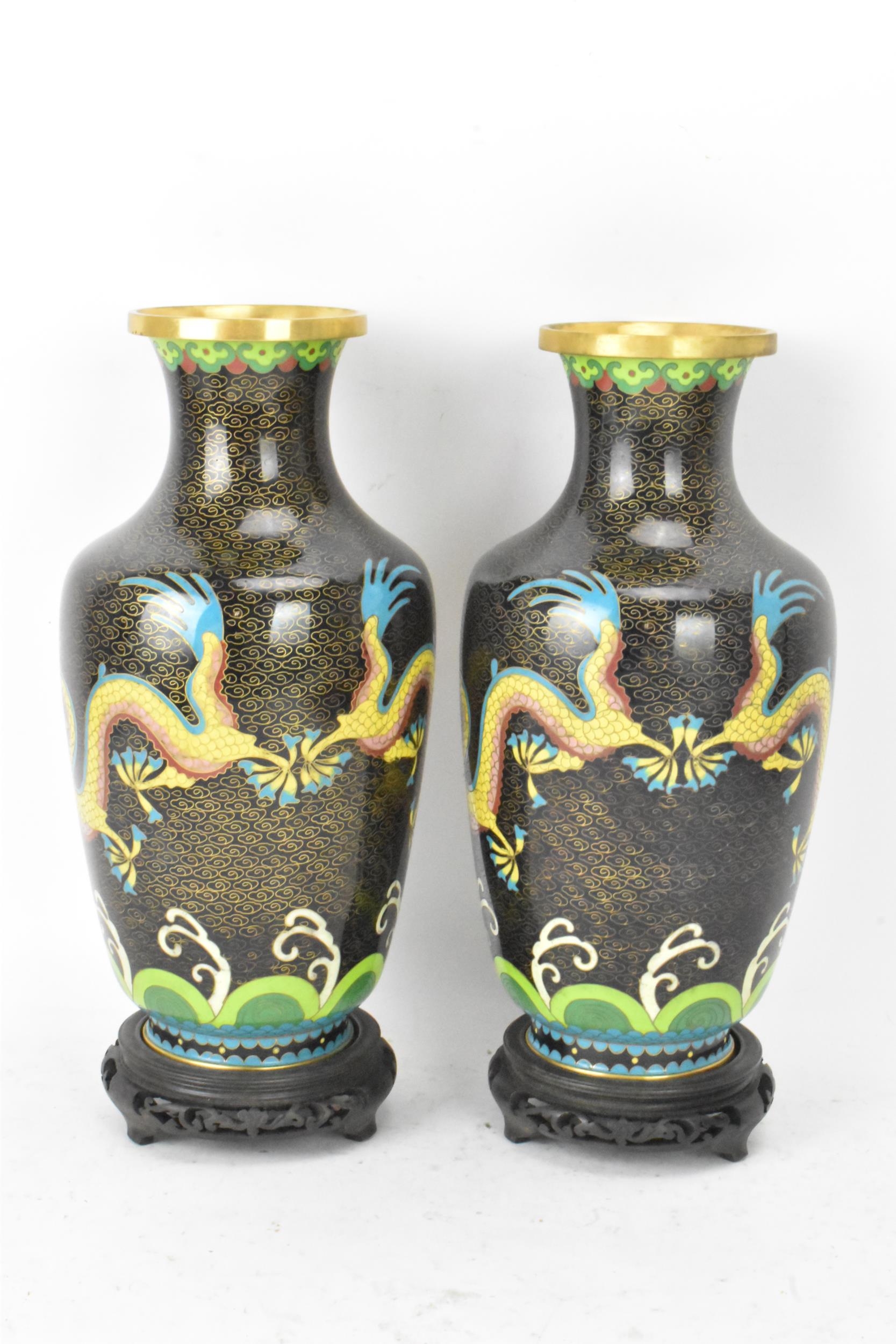 A pair of Chinese mid 20th century cloisonne vases and a bowl, all with black grounds decorated with - Image 5 of 12