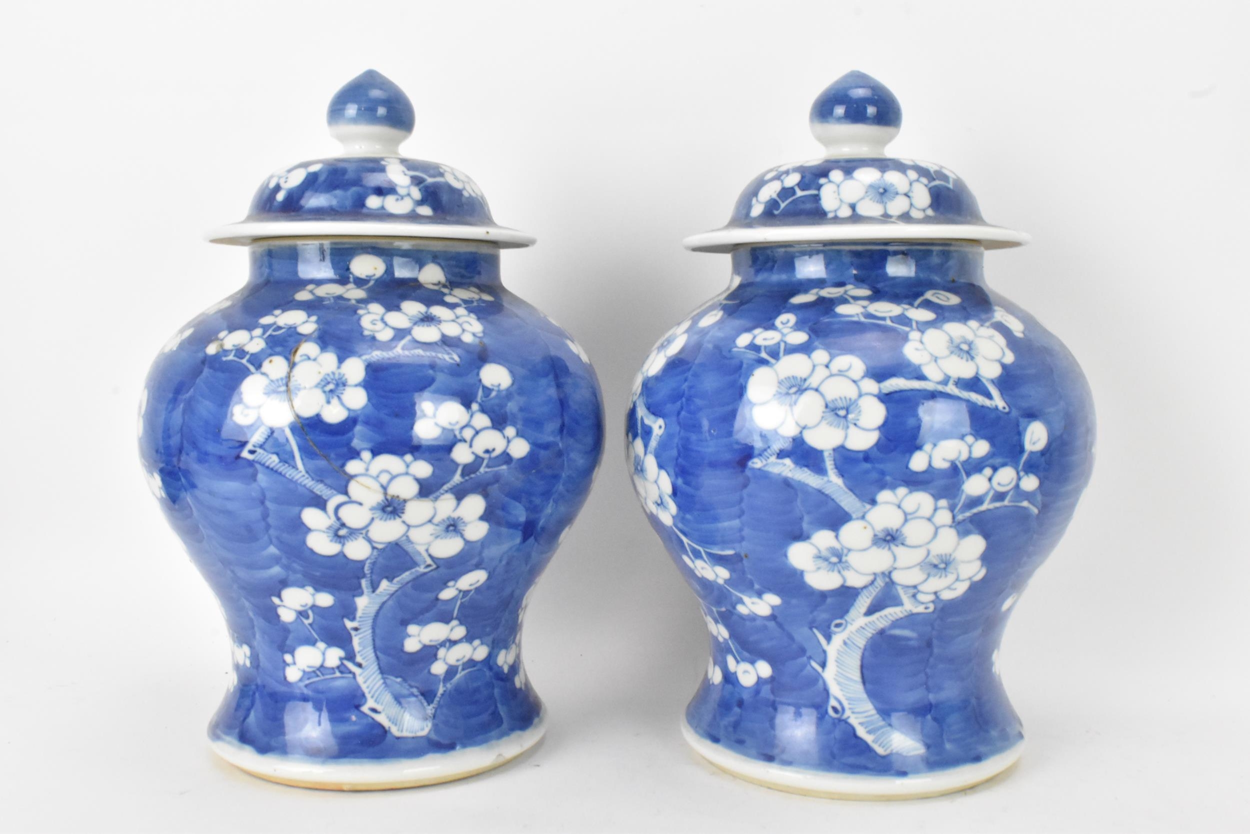 A pair of Chinese prunus pattern blue and white vases, late Qing Dynasty, both of baluster form with - Image 3 of 8