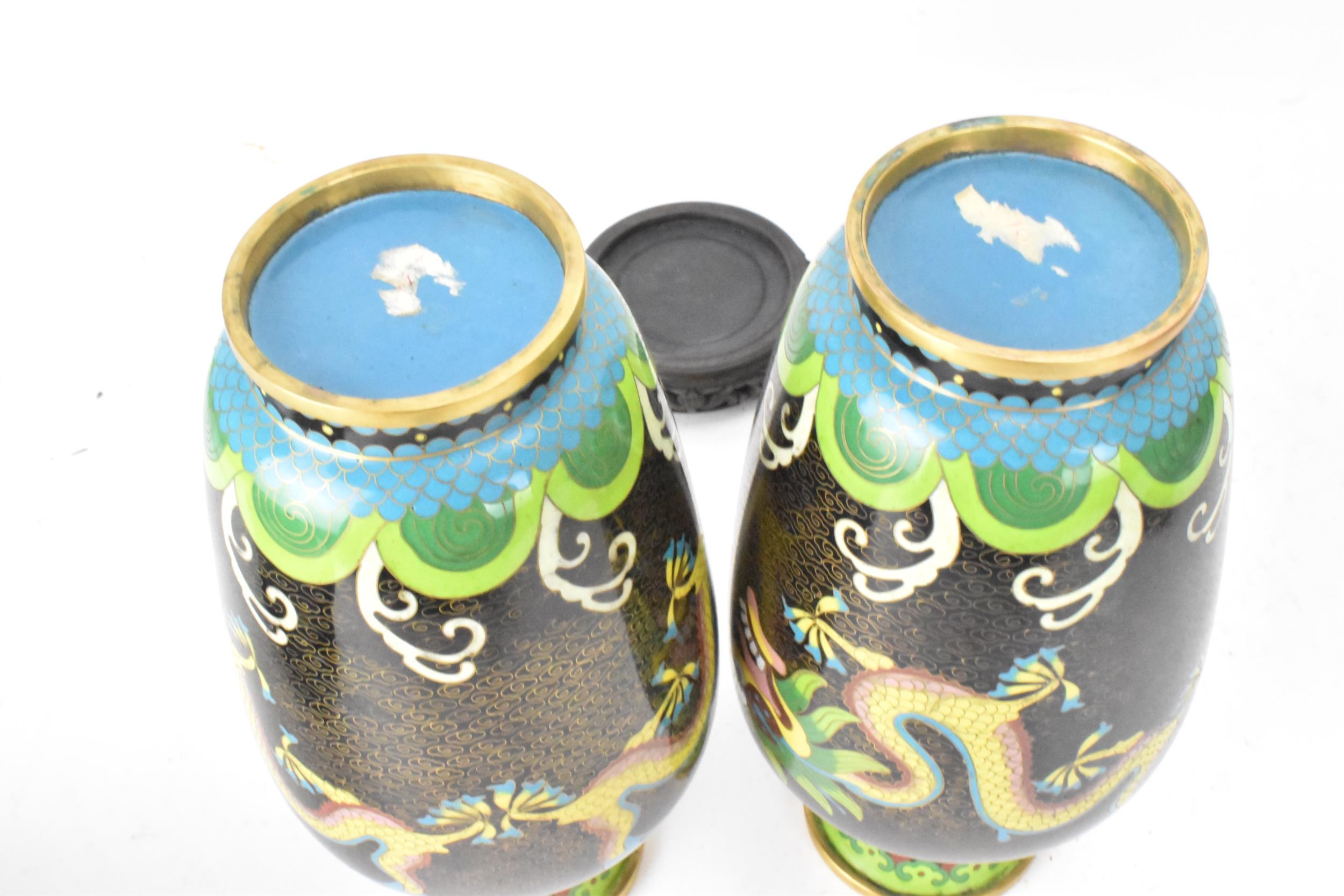 A pair of Chinese mid 20th century cloisonne vases and a bowl, all with black grounds decorated with - Image 7 of 12