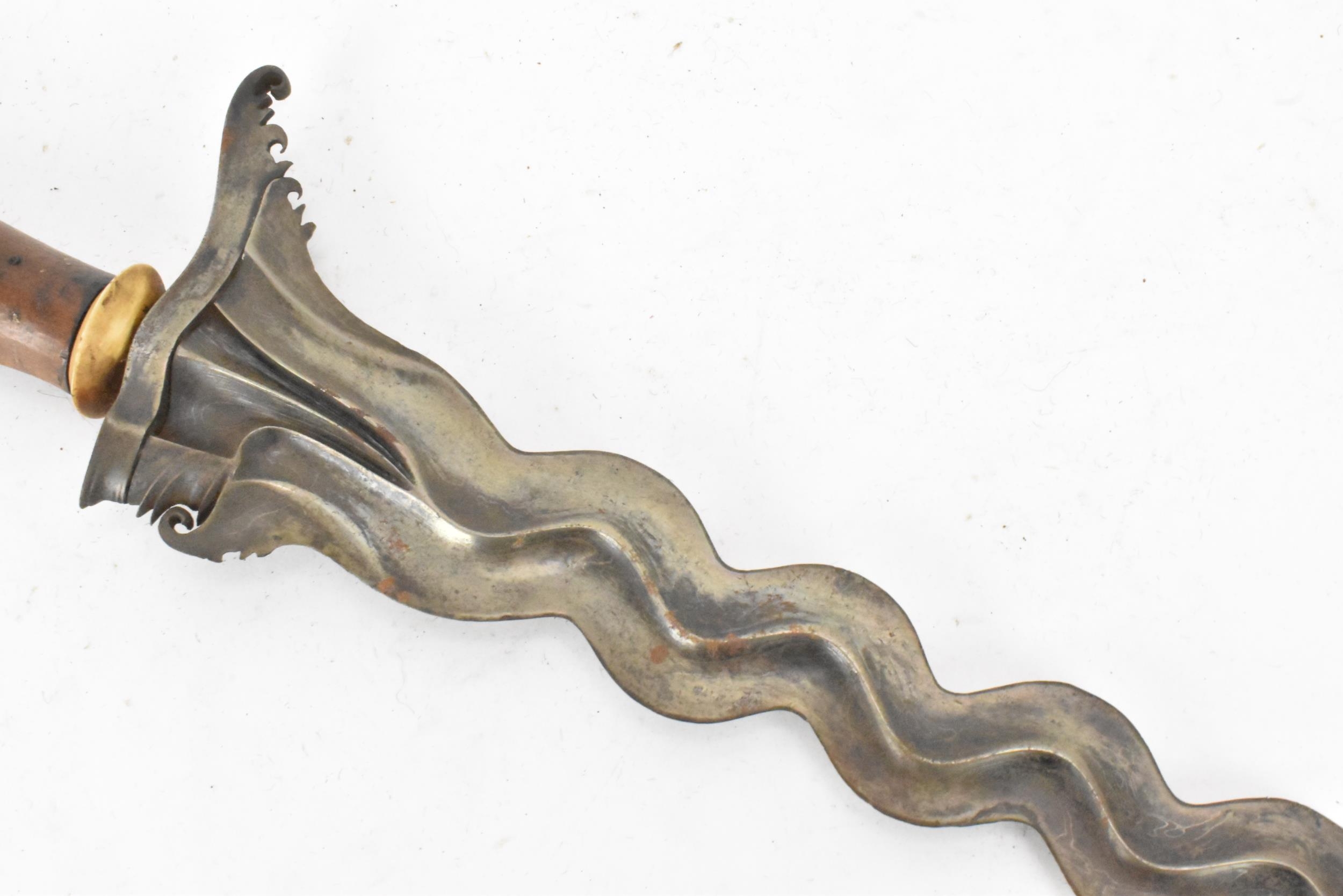 A 19th century Malayan Kris or Keris, having a double edged wavy blade with undulations, raised - Image 7 of 8