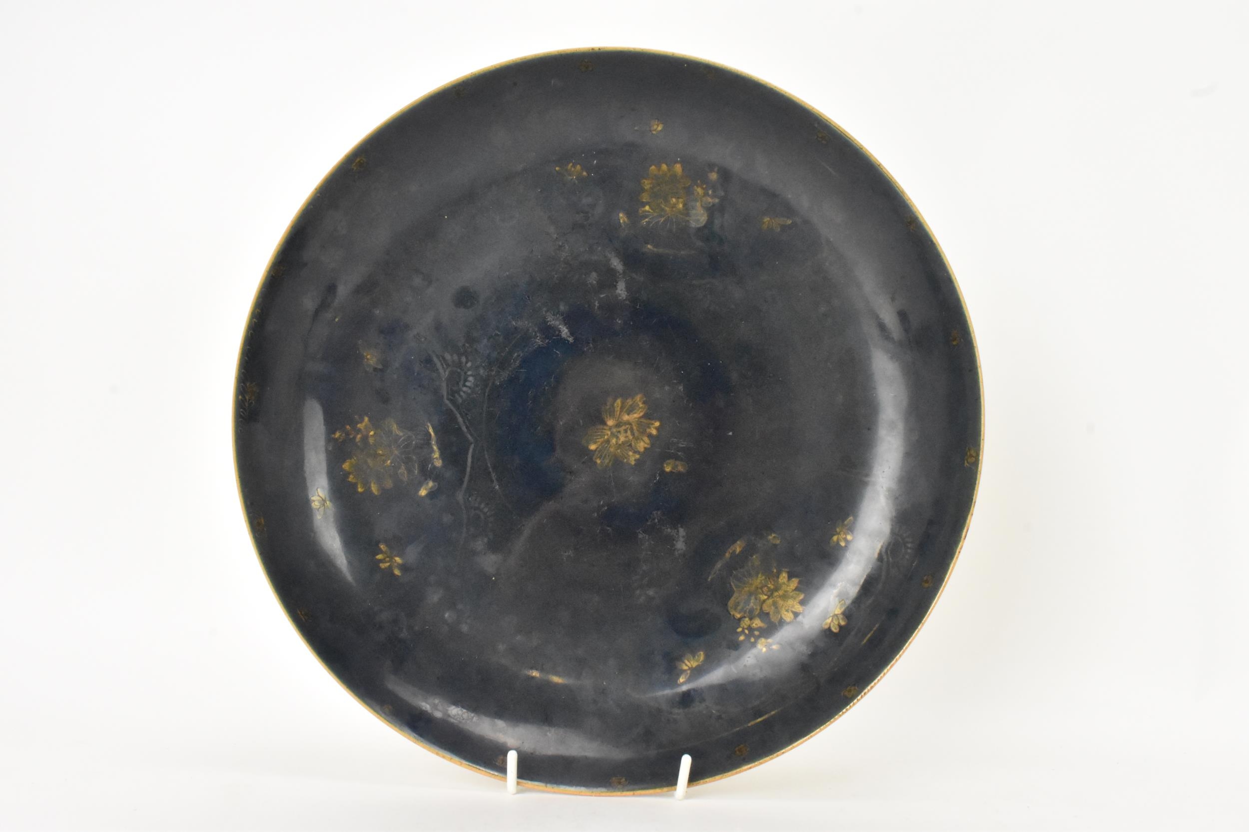 A Chinese Qing dynasty large powder blue dish, early 18th century, with gilt flora interior and