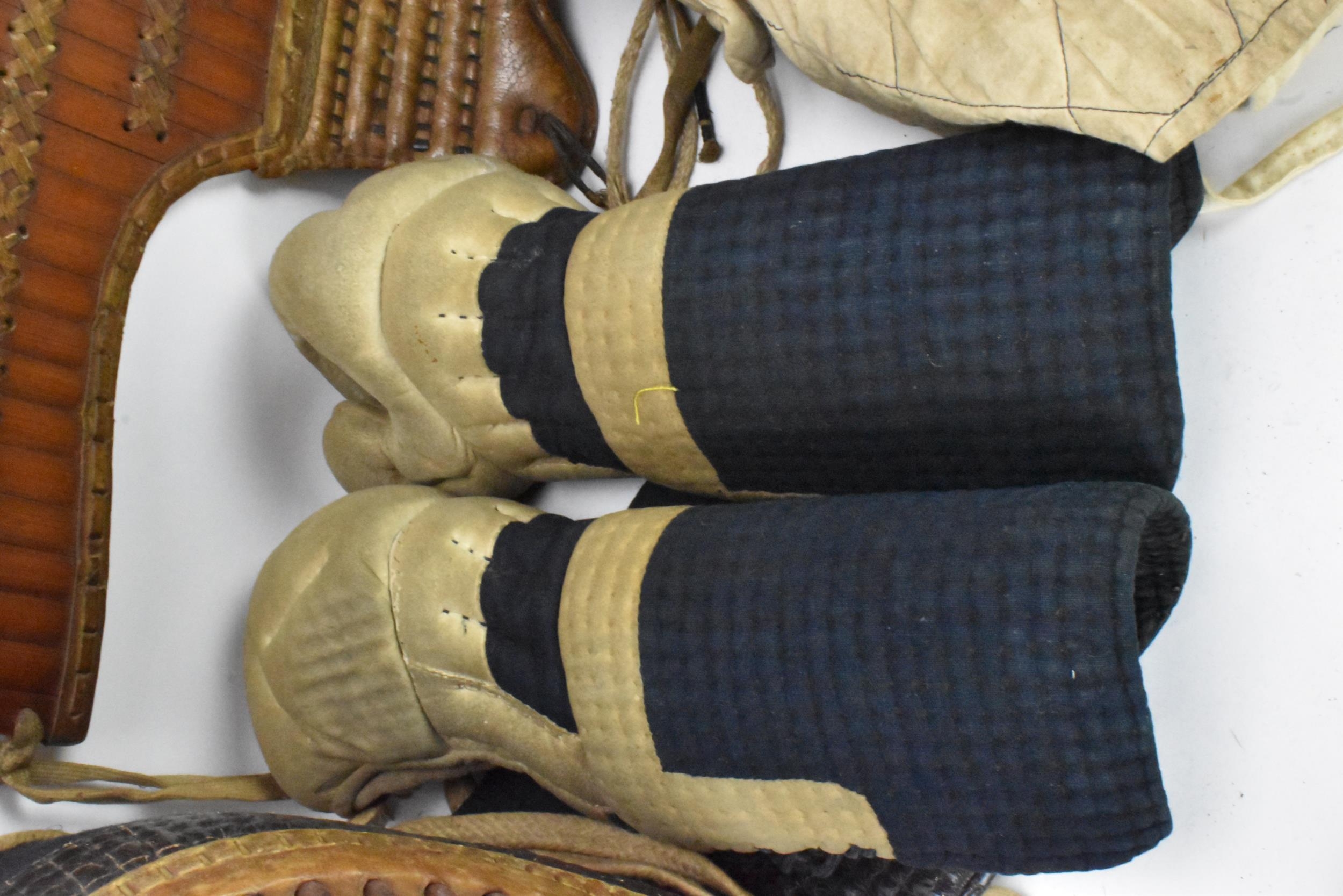 A Japanese Kendo uniform/suit of armour, comprising a helmet, knee pads, belts, jackets, hakama - Image 8 of 12