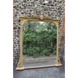 A 19th century French Louis XVI style large gilt wall mirror, having a sevres style painted plaque