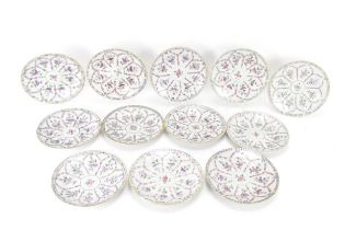 A set of twelve Chinese Qing dynasty famille rose plates, 18th century, having central flower