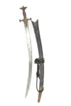 A 19th century Indian fighting Tulwar, having a 73cm curving single edged blade, the hilt with