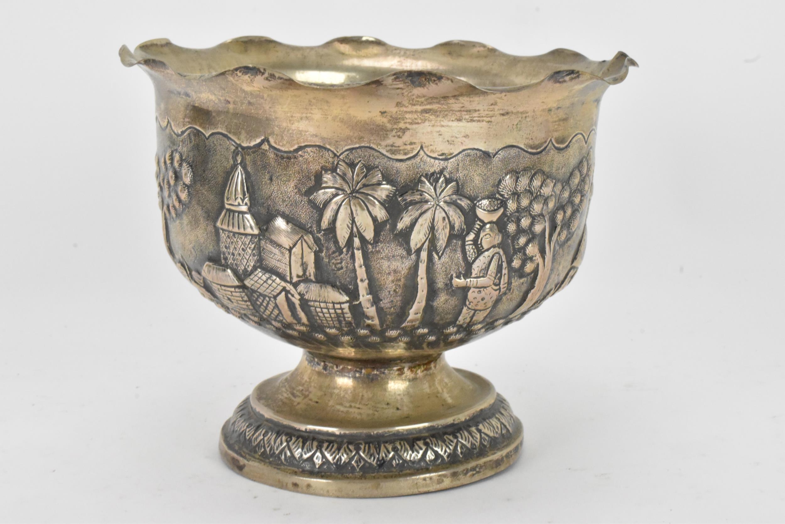 An early 20th century Anglo-Indian white metal bowl, having a crimped rim and embossed decoration