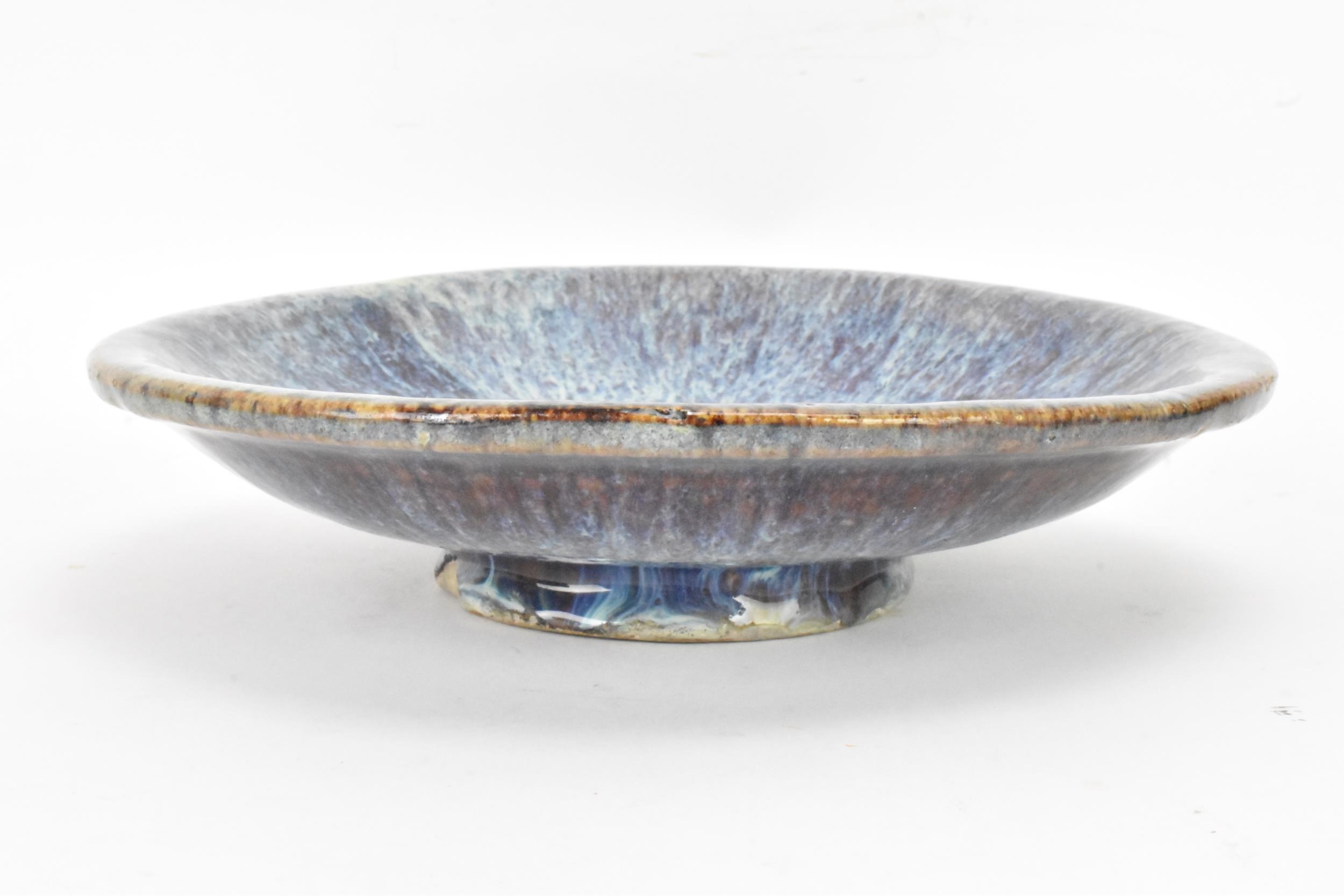 A Chinese Jun type bowl, possibly Shiwan ware, covered in a lustrous ochre turquoise and purple