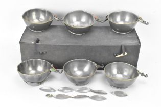 A set of six Chinese pewter bowls, each having a shaped rim and fluted body, the handles in the form