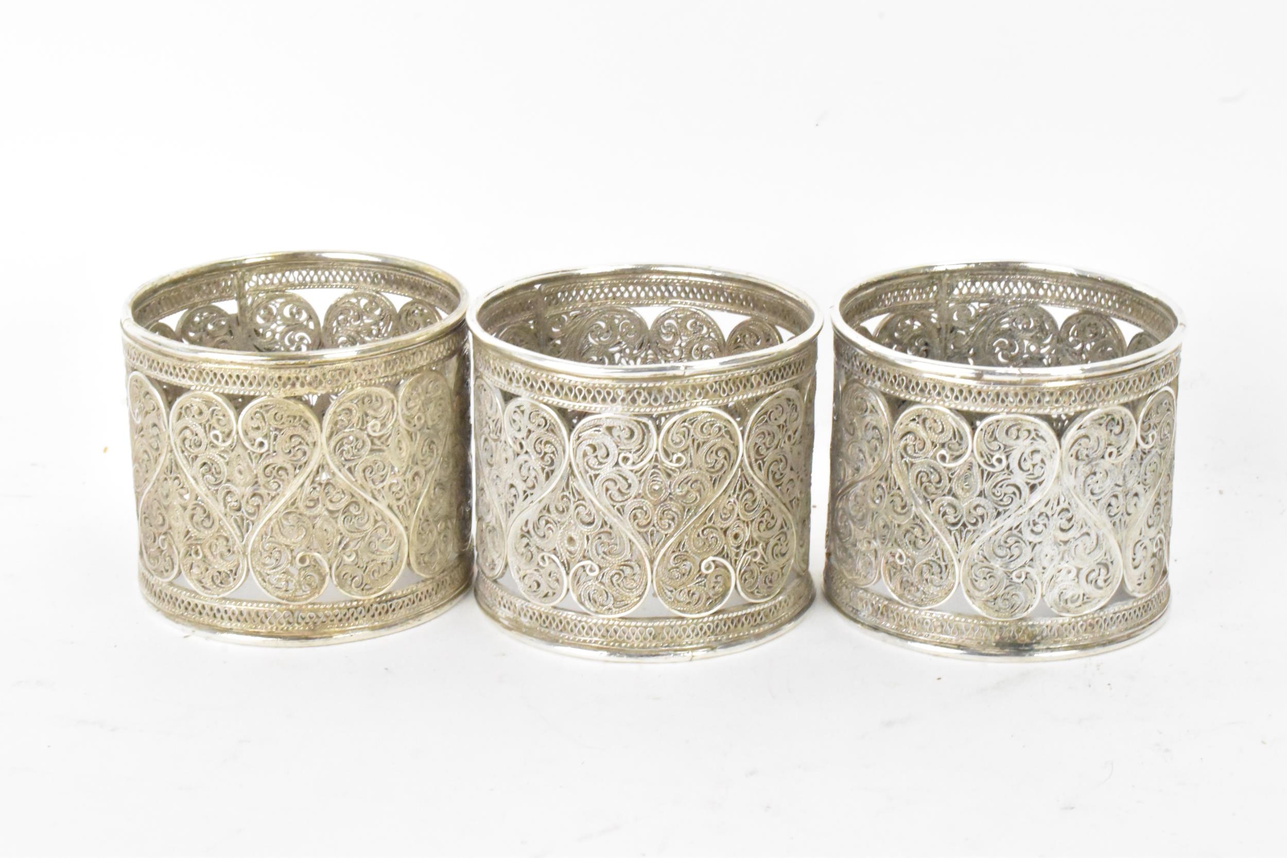 A set of six early 20th century Middle Eastern white metal filigree napkin rings, elaborately - Image 4 of 6