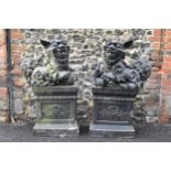 A pair of mid/late 20th century earthenware garden statues of Chinese foo dogs, both in a dark
