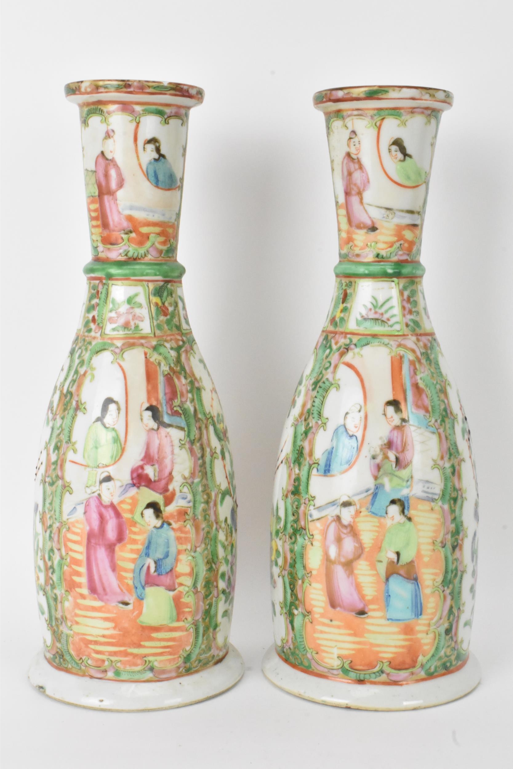 A pair of Chinese late 19th century Canton Famille Rose vases, of cylindrical tapered form, the