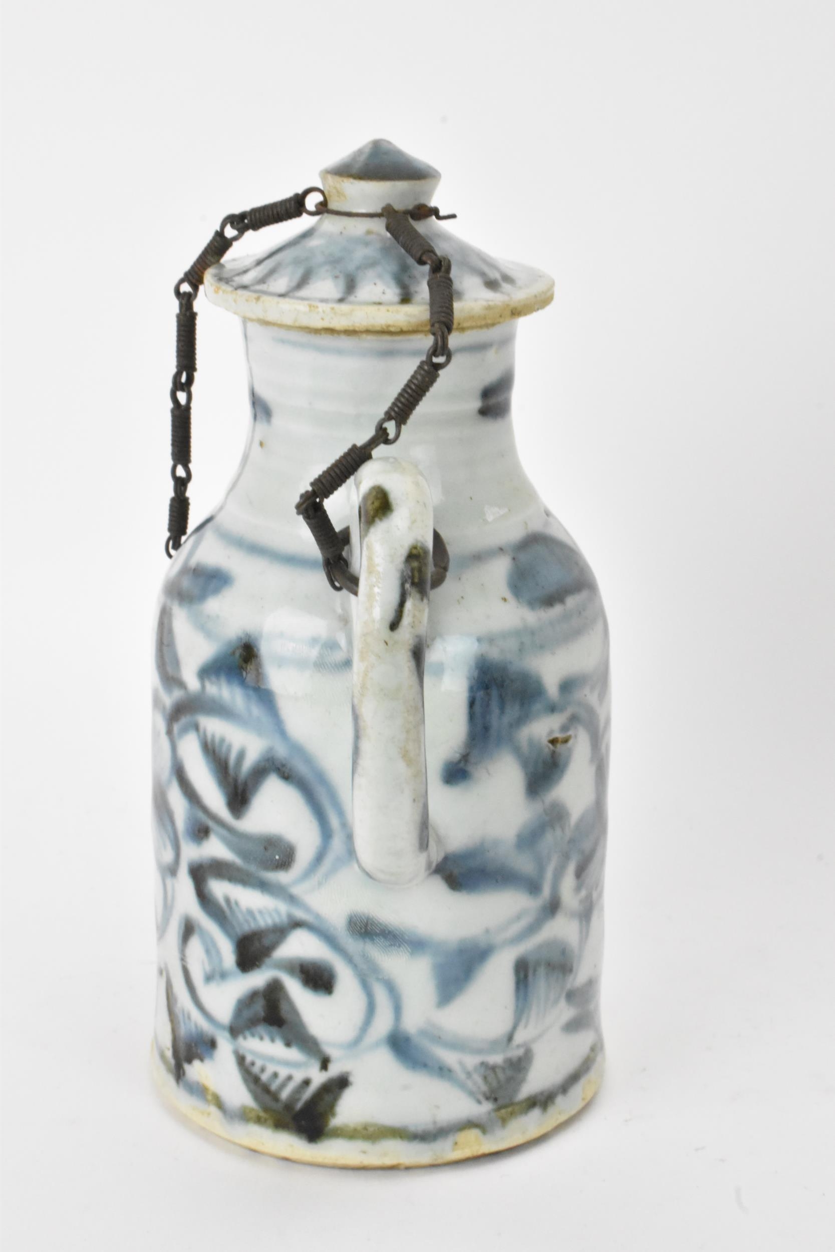 A Chinese ewer, late Ming dynasty, decorated in underglaze blue with flowers, loop shaped handle and - Image 4 of 7