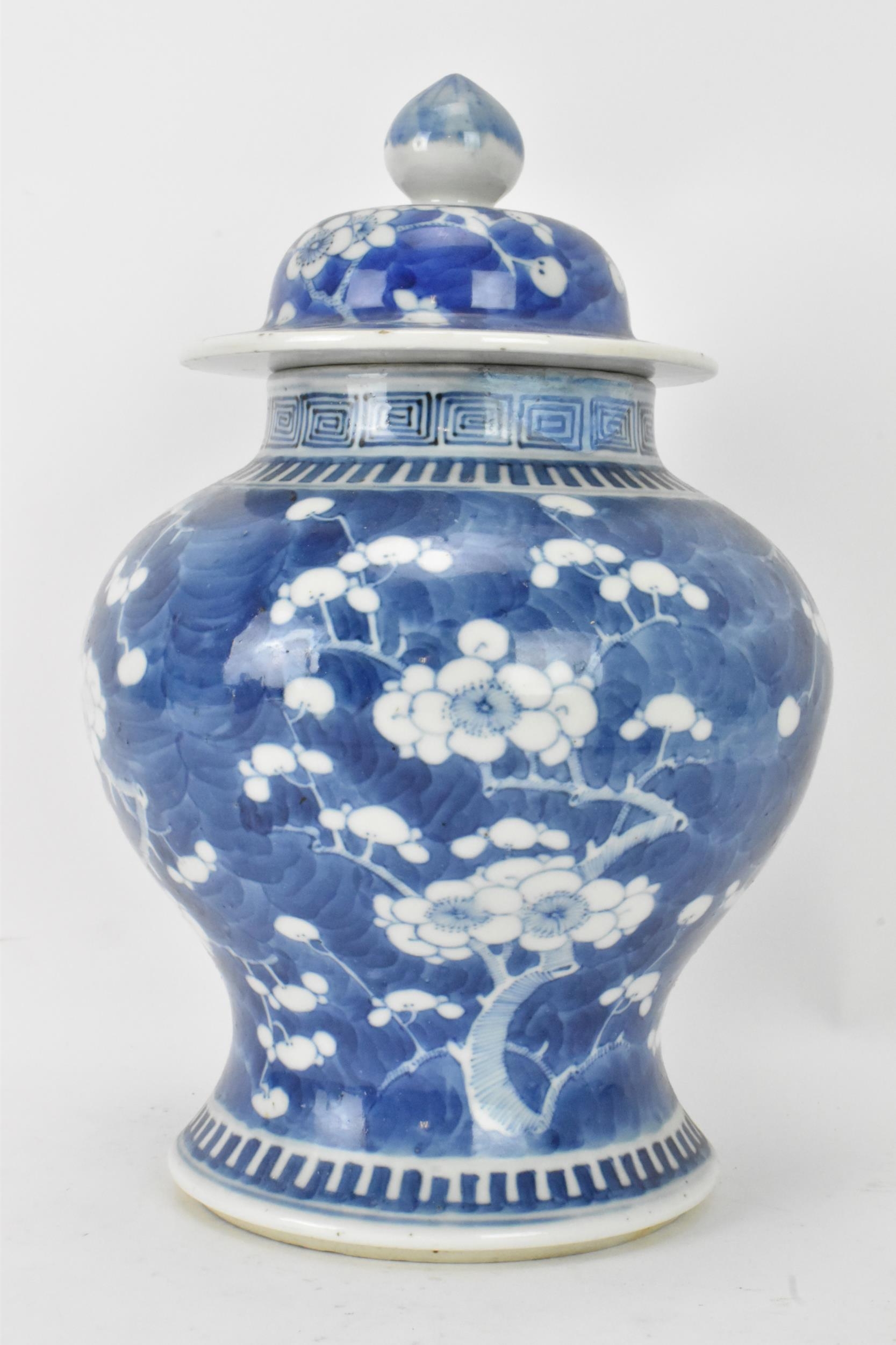 A Chinese prunus pattern blue and white vase, late Qing Dynasty, of baluster form with domed cover - Image 2 of 8