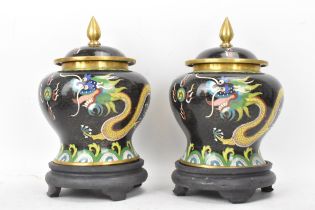 A pair of Chinese mid 20th century cloisonne lidded vases, each of baluster form body with black