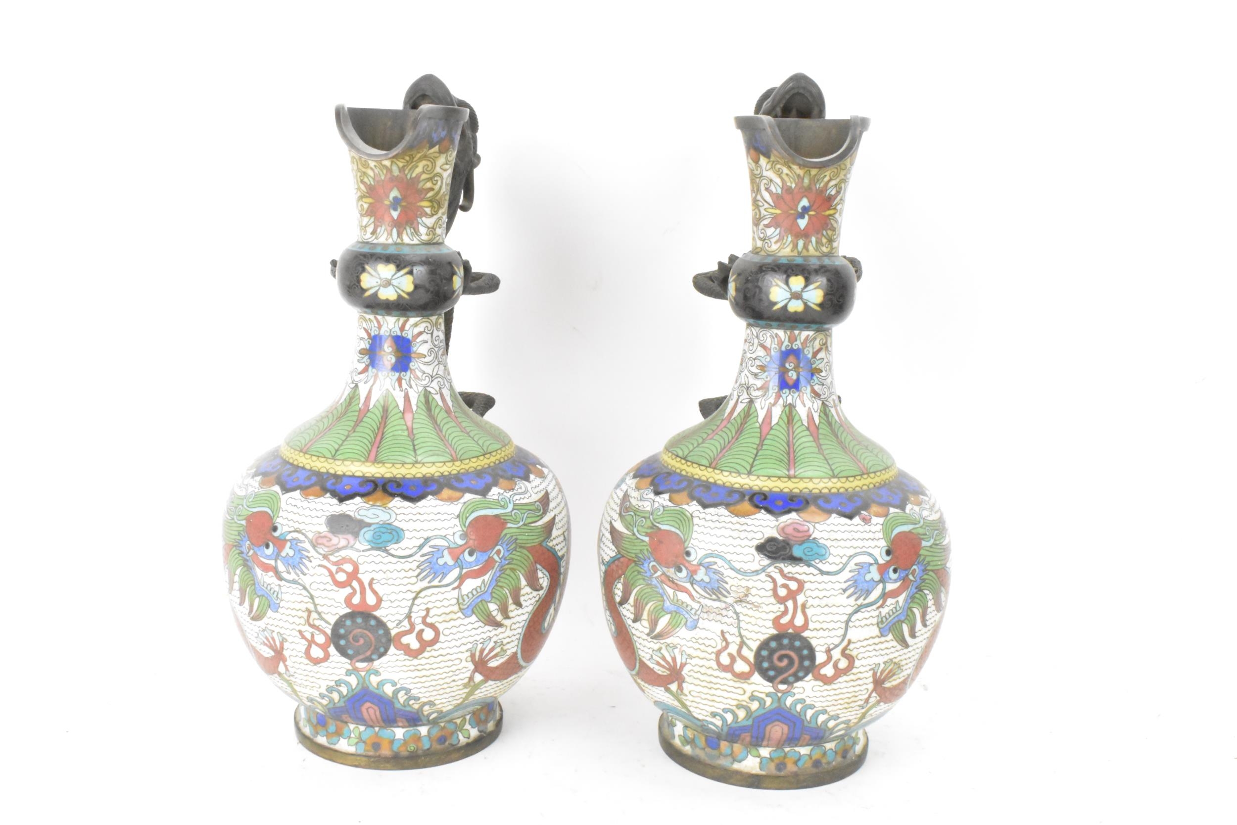 A pair of Chinese late Qing dynasty cloisonne ewers, both having a handle modelled in the form of - Image 4 of 6